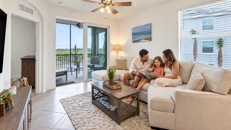 Parents reading a story with their daughter on a vacation-home sofa